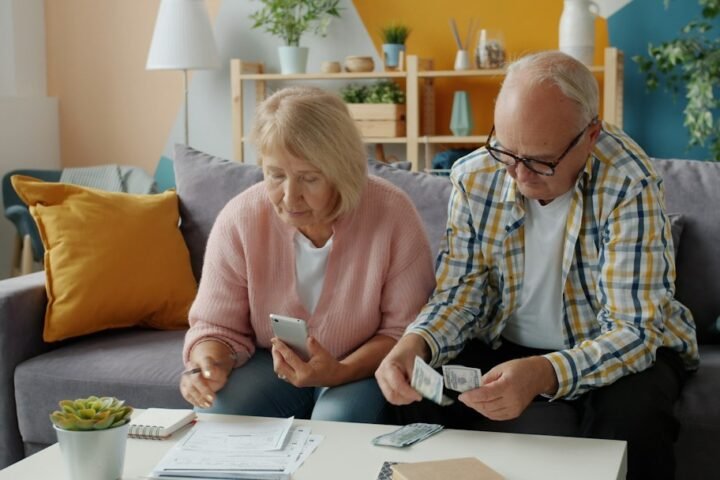 Older couple reviewing financial papers for retirement planning